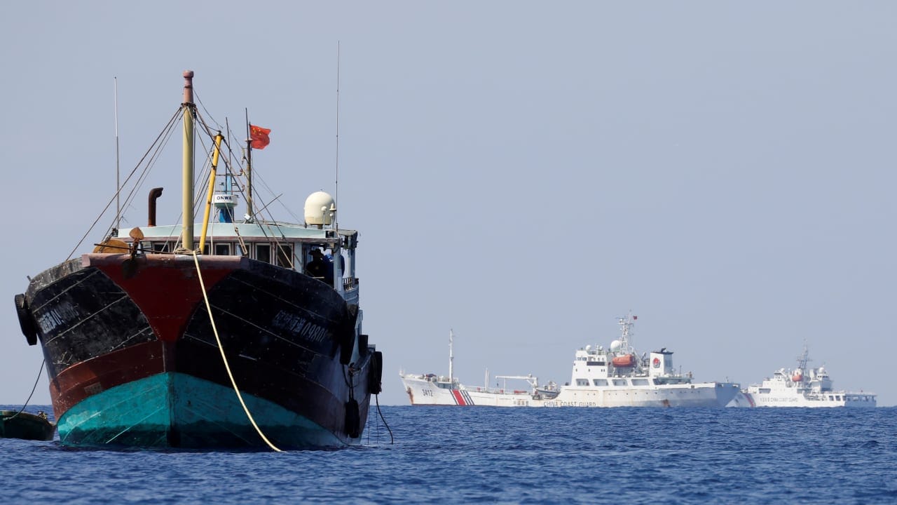 China Coast Guard vessels patrol past a Chinese fishing vessel at the disputed Scarborough Shoal, April 5, 2017; illustrative.