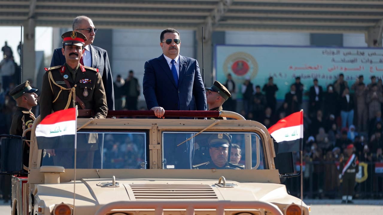 Iraqi Prime Minister Mohammed Shia al-Sudani (C) inspects a guard of honour during the Army Day celebrations, marking the 105th anniversary of the founding of Iraqi army, at Military College in Baghdad on January 6, 2026. 