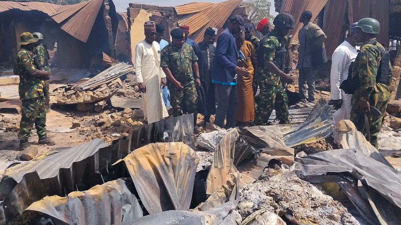 People look on as Nigerian Military arrives at Woro community, after an overnight attack by gunmen that killed dozens of residents, in Kaiama Local Government Area of Kwara State, Nigeria, February 4, 2026. 