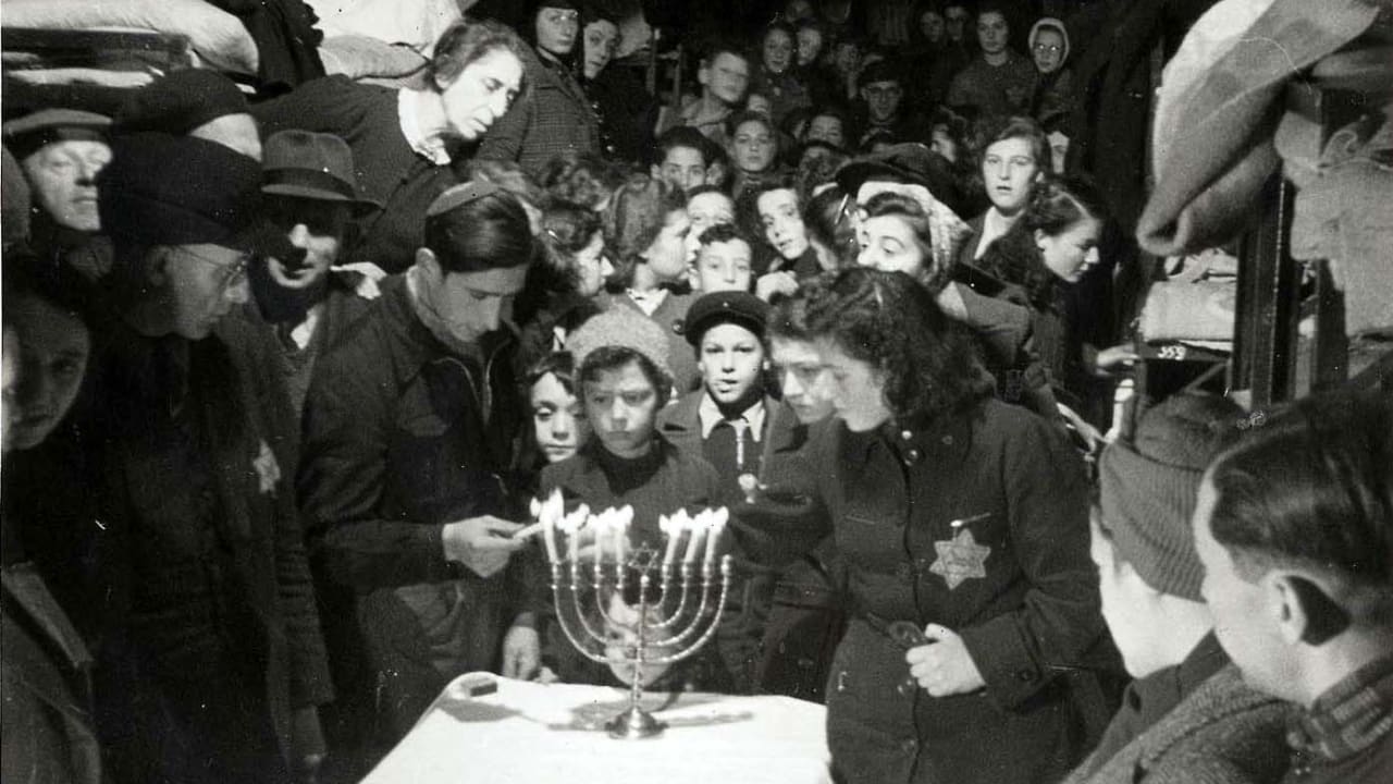 A Hanukkah candlelighting ceremony at the Westerbork transit camp in the Netherlands, December 1943. 