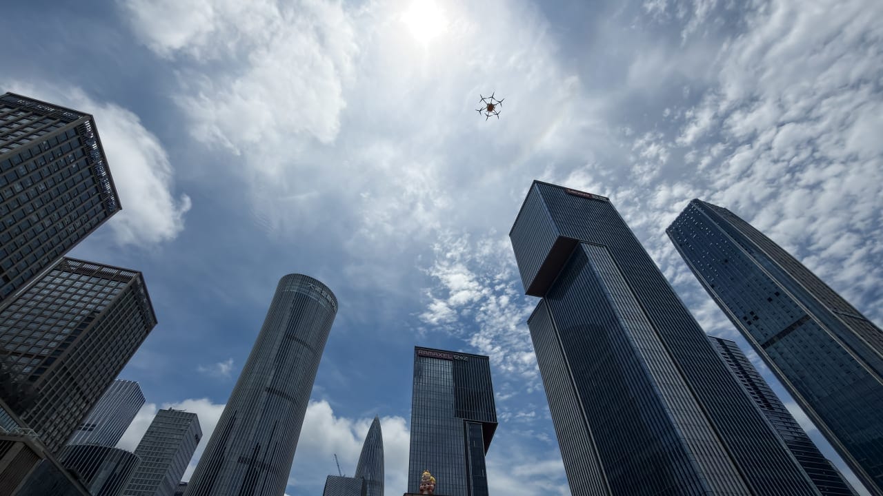 A delivery drone flies above skyscrapers in the Houhai Central Business District (CBD) in Nanshan District, China on May 22, 2026.
