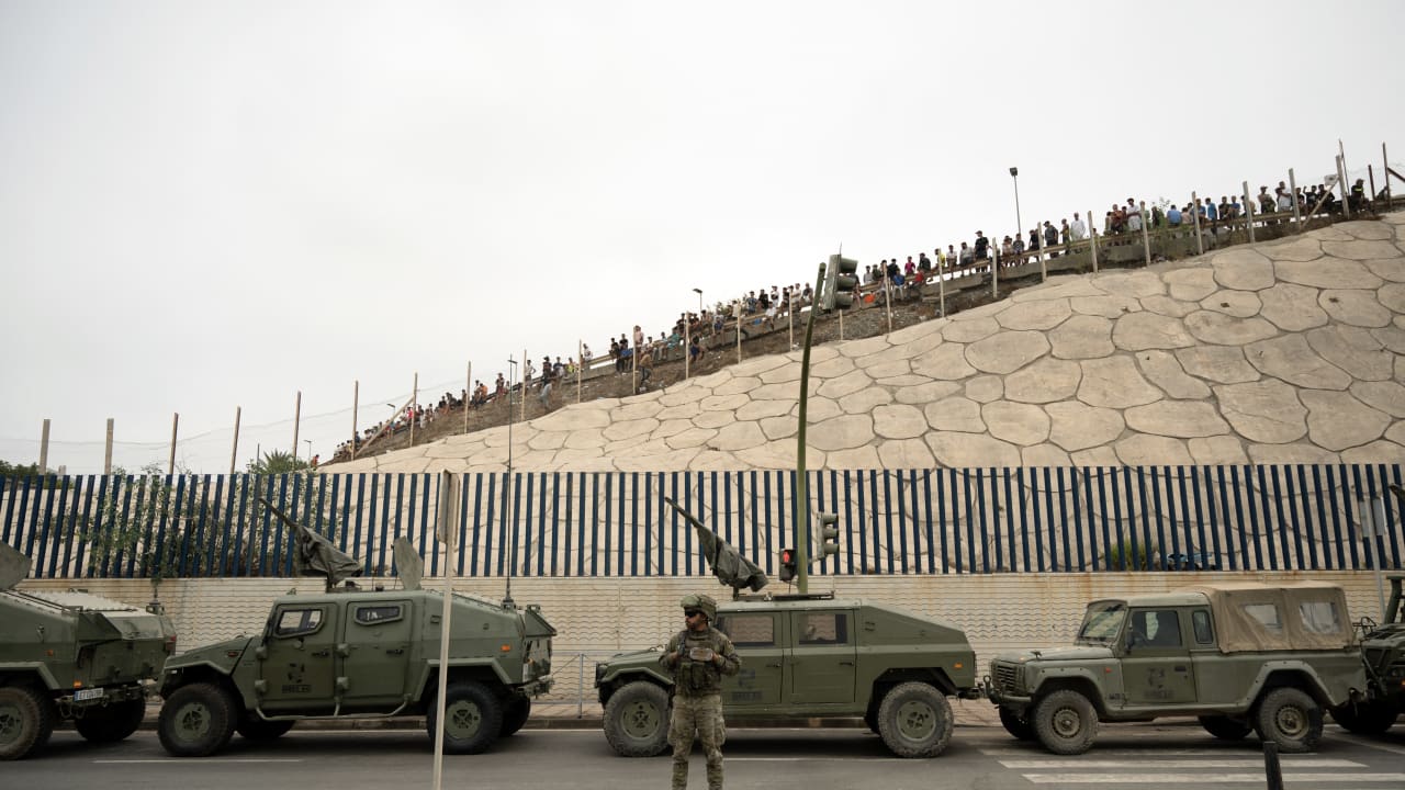 Spanish military personal patrol as migrants try to cross the border barrier with Morocco to enter Spain's north Africa's Ceuta enclave on July 31, 2026. 