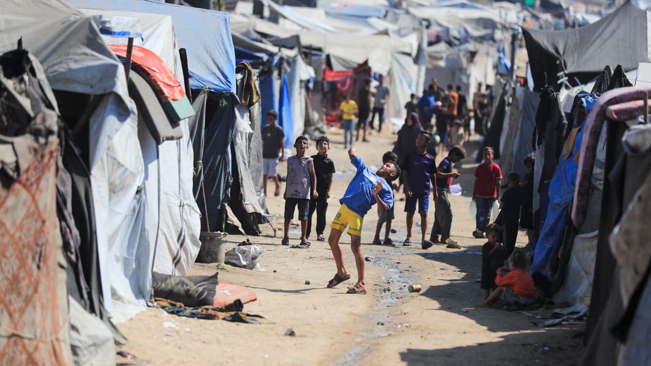 Children play as displaced Palestinians shelter at a tent camp, in Gaza City, July 31, 2026.