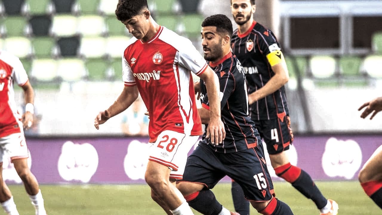 HAPOEL BEERSHEBA midfielder Niv Yehoshua (28) battles for possession during the Southern Reds’ hard-fought 1-0 victory over Red Star Belgrade in the first leg of UEFA Champions League third-round qualifying. 