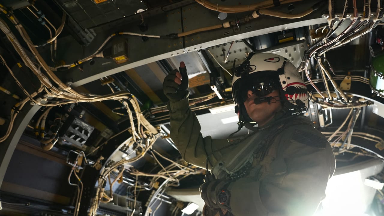 A US Navy aircrew member gives a thumbs-up inside an MV-22 Osprey aboard the aircraft carrier USS Theodore Roosevelt (CVN-71) while the ship is moored in Honolulu, Hawaii, during Exercise RIMPAC (Rim of the Pacific) 2026 on July 17, 2026. 
