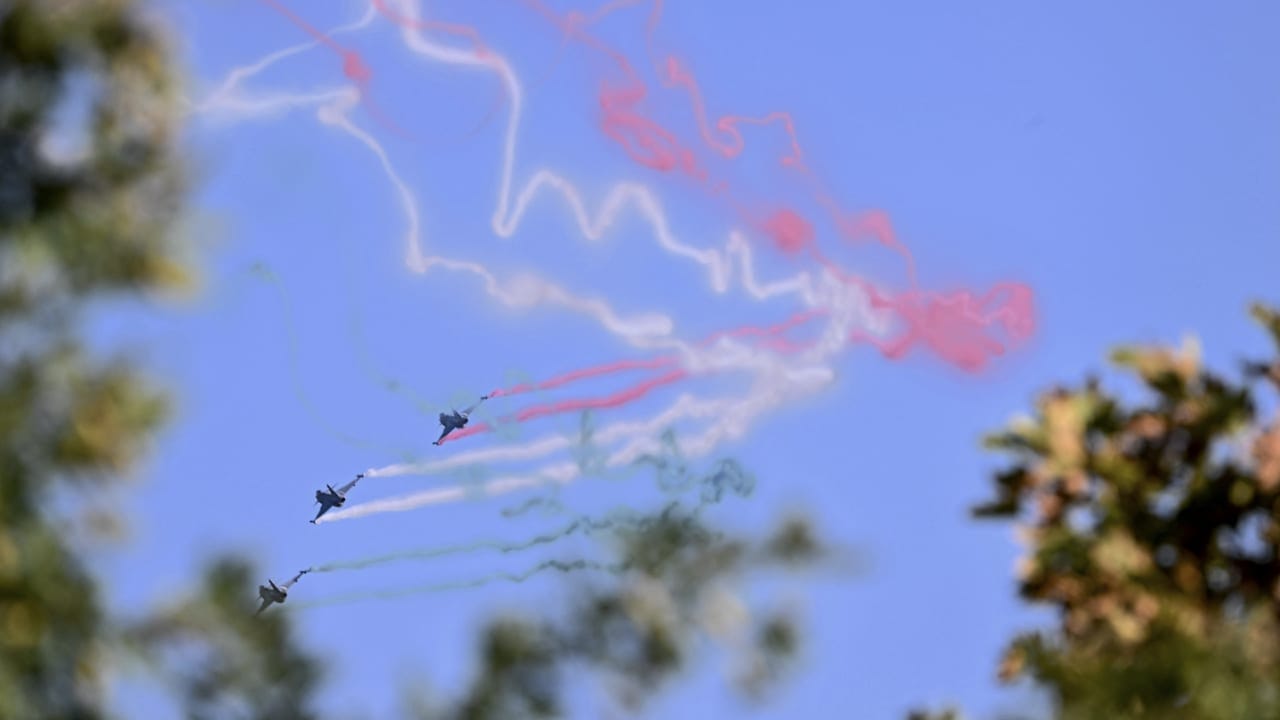 Gripen JAS 39 fighter aircraft of the Hungarian Air Force release trails of Hungary's national colours as they fly over the parliament building during a ceremony marking the country's national day attended by guests and ambassadors accredited to Hungary on August 20, 2026, in Budapest.
