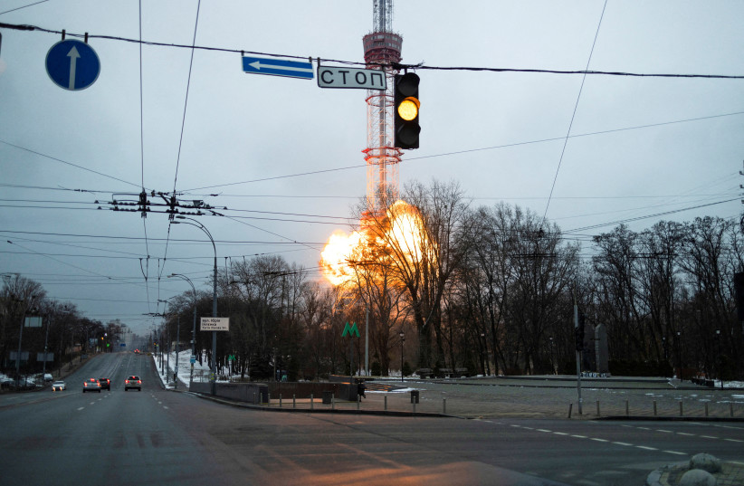  A blast is seen near a TV tower adjacent to the Babyn Yar Holocaust Memorial, amid Russia's invasion of Ukraine, in Kyiv, Ukraine March 1, 2022.  (photo credit: Carlos Barria/Reuters)