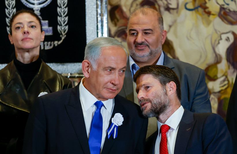 Likud leader MK Benjamin Netanyahu speaks with Religious Zionist party head MK Bezalel Smotrich at a swearing-in ceremony of the 25th Knesset, at the Israeli parliament in Jerusalem, November 15, 2022. (credit: OLIVIER FITOUSSI/FLASH90)