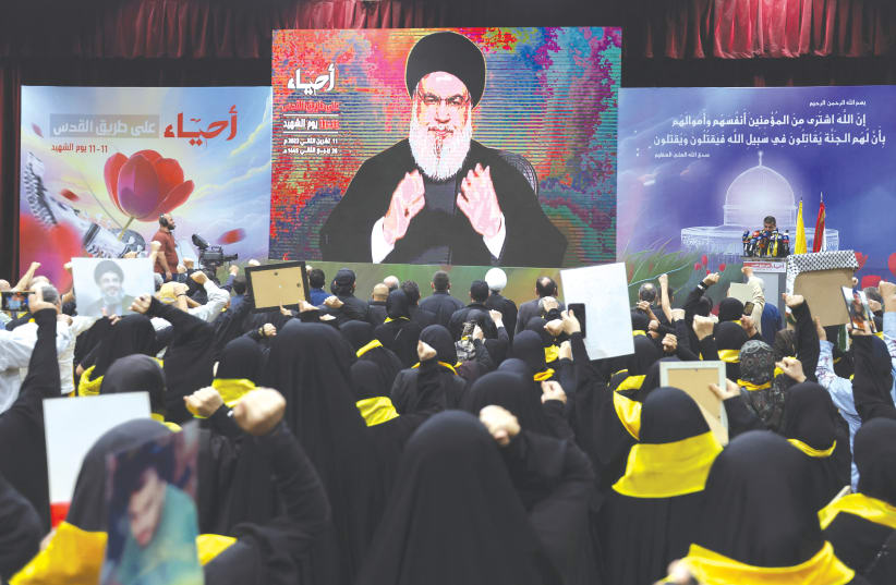  HEZBOLLAH LEADER Hassan Nasrallah addresses his supporters during a rally commemorating the annual Hezbollah Martyrs’ Day, in Beirut last month.  (photo credit: AZIZ TAHER/REUTERS)