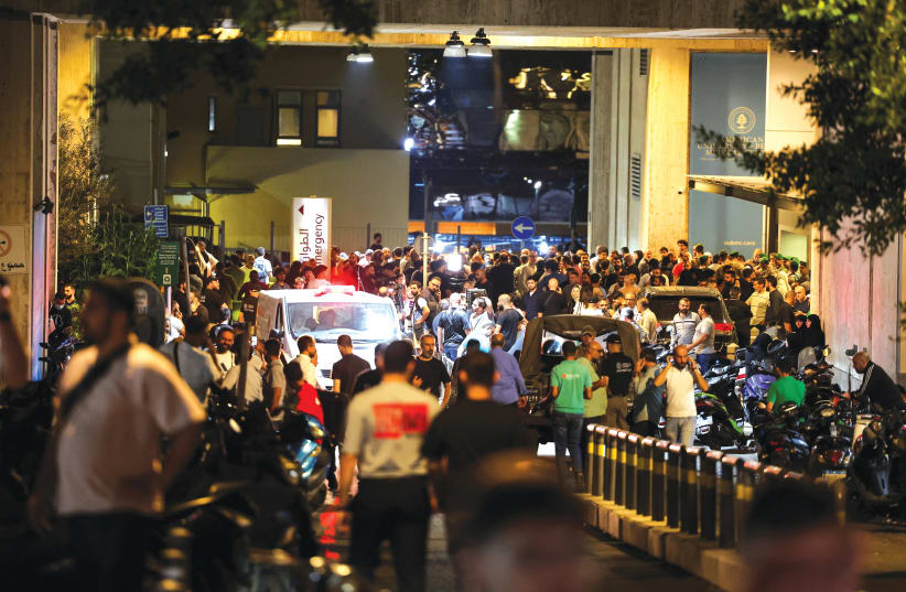  CROWDS GATHER outside American University of Beirut Medical Center after thousands of Hezbollah operatives were wounded when the pagers they use to communicate exploded across Lebanon, on Tuesday. (photo credit: MOHAMED AZAKIR/REUTERS)