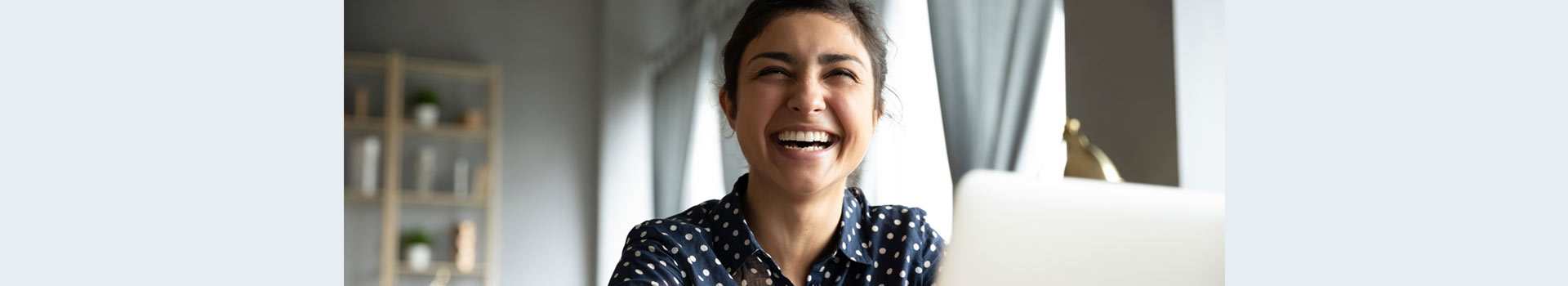 Smiling woman sitting in front of her laptop