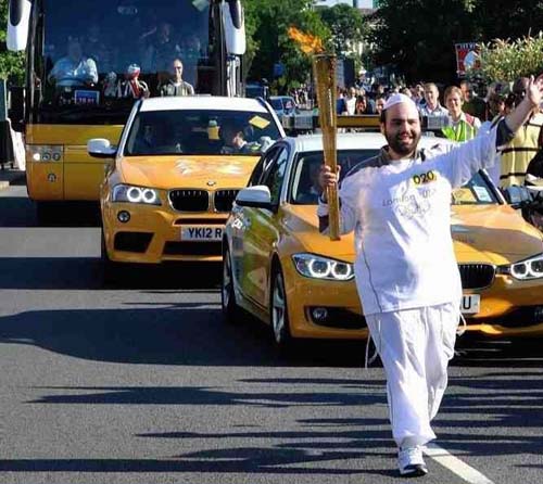 Founder of London Shomrim Carries Olympic Torch Efrayim Goldstein carries Olympic torch through London's streets.