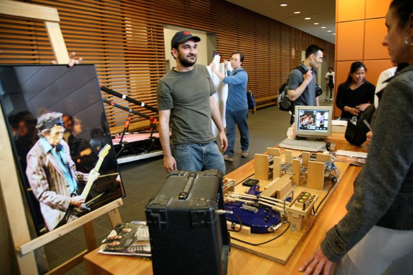 Engineering students showing a project on the main floor of the EV building at Concordia