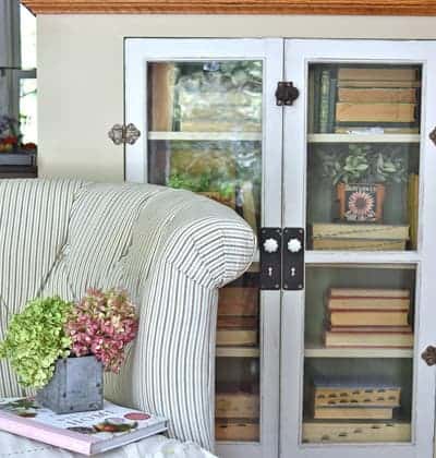 Vintage bookcase with old books and loveseat
