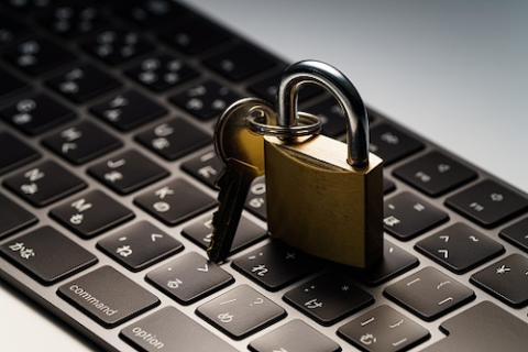 padlock with key place on top of computer keyboard