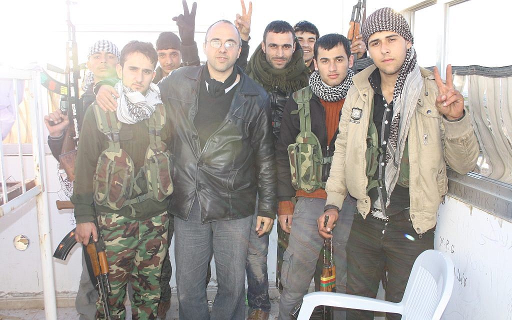 Jonathan Spyer, wearing a black leather jacket, meets with Kurdish YPG fighters in northern Syria in 2013. (Courtesy) Jonathan Spyer, wearing a black leather jacket, meets with Kurdish YPG fighters in northern Syria in 2013. (Courtesy)