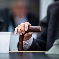 A 94-year-old former SS guard holds his walking stick at the beginning of a trial in Muenster, Germany, November 6, 2018. He is charged with accessory to murder for serving at the Nazis' Stutthof concentration camp. (Guido Kirchner/dpa via AP)