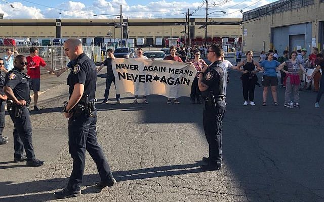 Police stand in front of protesters at a demonstration at an ICE detention center in Elizabeth, New Jersey, June 30, 2019. (Naftali Y. Ehrenkranz via JTA)