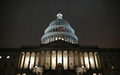 Lights shine on the U.S. Capitol dome, Monday, Dec. 9, 2019, after the House Judiciary Committee heard investigative findings in the impeachment inquiry of US President Donald Trump on Capitol Hill in Washington. (AP Photo/Patrick Semansky)