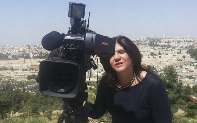 In this undated photo provided by Al Jazeera Media Network, reporter Shireen Abu Akleh stands next to a TV camera above the Old City of Jerusalem. (Al Jazeera Media Network via AP) In this undated photo provided by Al Jazeera Media Network, reporter Shireen Abu Akleh stands next to a TV camera above the Old City of Jerusalem. (Al Jazeera Media Network via AP)