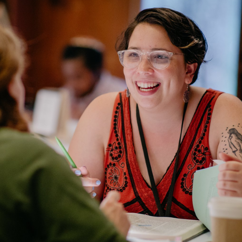 Lonnie, sitting at a table, is smiling at someone.