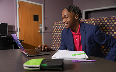 Male student working on a laptop