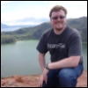 mark: A photo of Mark kneeling on top of the Taal Volcano in the Philippines. It was a long hike. (pic#6498896) (Default)
