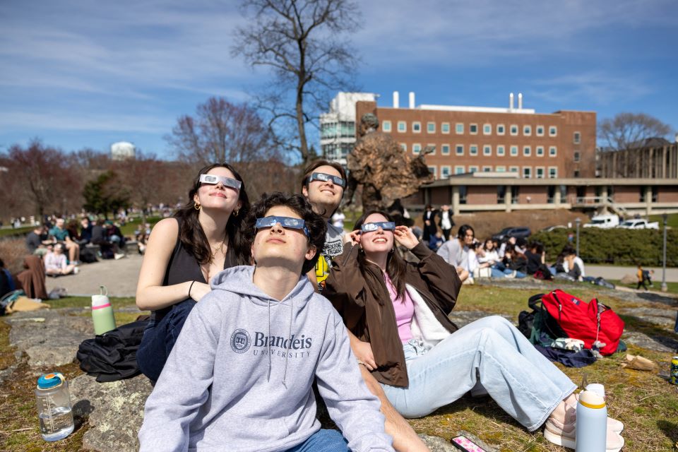 Students with eclipse glasses looking up.